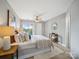 Bright bedroom with neutral tones, ceiling fan, and a sliding glass door to outdoor views at 18817 Nautical Dr # 302, Cornelius, NC 28031