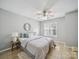 Bright bedroom with a ceiling fan, large window, and soft, neutral decor at 18817 Nautical Dr # 302, Cornelius, NC 28031