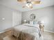 Bright bedroom features a ceiling fan, light wood floors, and a walk in closet with mirrored doors at 18817 Nautical Dr # 302, Cornelius, NC 28031