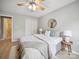 Bright bedroom features a ceiling fan, light wood floors, and a walk in closet with mirrored doors at 18817 Nautical Dr # 302, Cornelius, NC 28031