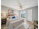 Cozy bedroom with a ceiling fan, warm lighting, and a sliding glass door to a balcony at 18817 Nautical Dr # 302, Cornelius, NC 28031