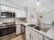 Bright kitchen featuring modern appliances, stainless steel sink, and open view to living spaces at 18817 Nautical Dr # 302, Cornelius, NC 28031