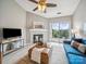 Comfortable living room with a fireplace, light walls, and a ceiling fan at 18817 Nautical Dr # 302, Cornelius, NC 28031