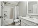 Neutrally-toned bathroom features a single sink vanity and shower-tub combo with white finishes at 1970 Topaz Plz, Davidson, NC 28036