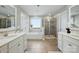 Bright bathroom featuring double vanities, soaking tub, and a separate tiled shower at 1970 Topaz Plz, Davidson, NC 28036