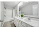 Bright bathroom features a double sink vanity and shower-tub combo with white finishes at 1970 Topaz Plz, Davidson, NC 28036