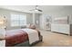 Bright bedroom with a cozy seating area, a ceiling fan, and a white dresser at 1970 Topaz Plz, Davidson, NC 28036