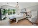 Well-lit bedroom features a statement chandelier, comfortable chair, and a bright outside view at 1970 Topaz Plz, Davidson, NC 28036
