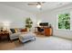 Cozy bedroom with seating, workspace, and ample natural light from the large window at 1970 Topaz Plz, Davidson, NC 28036