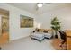 Carpeted bedroom boasts a comfortable seating area and a bright window, creating a relaxing space at 1970 Topaz Plz, Davidson, NC 28036