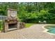 Brick outdoor fireplace and seating area create a cozy and inviting backyard space at 1970 Topaz Plz, Davidson, NC 28036
