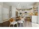 Bright dining area with modern lighting, stainless appliances, and kitchen island at 1970 Topaz Plz, Davidson, NC 28036