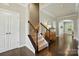Elegant foyer with hardwood floors, staircase, and stylish console table at 1970 Topaz Plz, Davidson, NC 28036