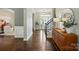 Elegant foyer with hardwood floors, staircase, and stylish console table and decor at 1970 Topaz Plz, Davidson, NC 28036