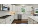 Well-lit kitchen with white cabinets, stainless steel appliances, and tile backsplash at 1970 Topaz Plz, Davidson, NC 28036