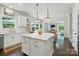 Bright kitchen with island, stainless appliances, and dark wood floors; a chef's dream! at 1970 Topaz Plz, Davidson, NC 28036