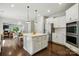 Modern kitchen featuring stainless steel appliances, center island, and dark wood floors at 1970 Topaz Plz, Davidson, NC 28036