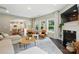 Inviting living room with fireplace, large windows, and open access to the kitchen at 1970 Topaz Plz, Davidson, NC 28036