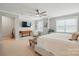 Large main bedroom boasts natural light, ceiling fan, and adjoins a separate seating area at 1970 Topaz Plz, Davidson, NC 28036