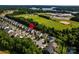 Aerial view of community homes near school, green space, and lake at 203 Rustling Waters Dr, Mooresville, NC 28117