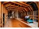 Unfinished attic space with wooden beams, flooring, and ample room for storage or potential conversion at 203 Rustling Waters Dr, Mooresville, NC 28117