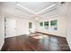 Spacious bedroom with modern tray ceiling, hardwood floors, and ample natural light at 203 Rustling Waters Dr, Mooresville, NC 28117