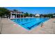 Community pool with lap lanes, ladders, and poolside seating and tables at 203 Rustling Waters Dr, Mooresville, NC 28117