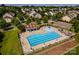 Aerial view of the community pool with ample seating, a playground, and a clubhouse at 203 Rustling Waters Dr, Mooresville, NC 28117