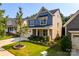 Inviting two-story home with manicured lawn, stone accents, and a welcoming front porch in a suburban setting at 203 Rustling Waters Dr, Mooresville, NC 28117