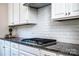 Gourmet kitchen featuring granite countertops, white cabinets, and stainless steel gas range at 203 Rustling Waters Dr, Mooresville, NC 28117
