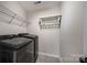 Laundry room with front-load washer and dryer, shelving and utility rack at 203 Rustling Waters Dr, Mooresville, NC 28117