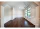 Bright living room features hardwood floors, large windows for natural light, and white molding throughout at 203 Rustling Waters Dr, Mooresville, NC 28117