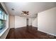 Spacious living room featuring hardwood floors, a ceiling fan, and large windows at 203 Rustling Waters Dr, Mooresville, NC 28117