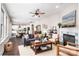 Open-concept living room with hardwood floors, a fireplace, and view of the kitchen and dining area at 203 Rustling Waters Dr, Mooresville, NC 28117