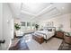Elegant main bedroom suite with trey ceiling, hardwood floors, and ample natural light at 203 Rustling Waters Dr, Mooresville, NC 28117