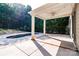Covered back patio with ceiling fan that overlooks the in-ground pool and backyard area at 203 Rustling Waters Dr, Mooresville, NC 28117