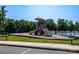 Community playground with slides, swings and a picnic table next to the pool at 203 Rustling Waters Dr, Mooresville, NC 28117