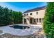 Backyard swimming pool surrounded by mature landscaping and a covered patio perfect for entertaining at 203 Rustling Waters Dr, Mooresville, NC 28117