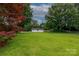 Expansive grassy backyard with mature trees and a storage shed at 205 Hillcrest Ave, Rock Hill, SC 29732