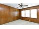 Bedroom features wood-paneled walls, ceiling fan, and natural light at 205 Hillcrest Ave, Rock Hill, SC 29732