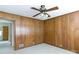 Bedroom features wood-paneled walls, ceiling fan, and natural light at 205 Hillcrest Ave, Rock Hill, SC 29732