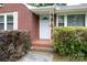 Close-up of the brick home's entry way, framed by bushes, and steps at 205 Hillcrest Ave, Rock Hill, SC 29732