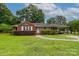 Charming red brick home with a well-manicured lawn, covered parking, and a stone walkway at 205 Hillcrest Ave, Rock Hill, SC 29732