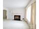 Spacious living room features a fireplace, large window, and neutral carpeting at 205 Hillcrest Ave, Rock Hill, SC 29732