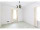 An empty living room with light green carpet, white walls, and antique light fixture at 205 Hillcrest Ave, Rock Hill, SC 29732