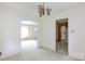 View from the empty living room with light green carpet, and white walls, looking into other rooms at 205 Hillcrest Ave, Rock Hill, SC 29732