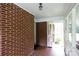 Inside view of the screened porch with a brick wall, and tile flooring at 205 Hillcrest Ave, Rock Hill, SC 29732