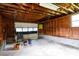 Interior view of a shed featuring wooden walls, exposed beams, and a garage door at 205 Hillcrest Ave, Rock Hill, SC 29732