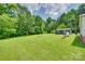 A spacious backyard features a shed and tree line in background at 284 Cedar Grove Rd, Clover, SC 29710