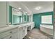 Well lit bathroom featuring dual sinks, bathtub and a block window for natural lighting at 284 Cedar Grove Rd, Clover, SC 29710